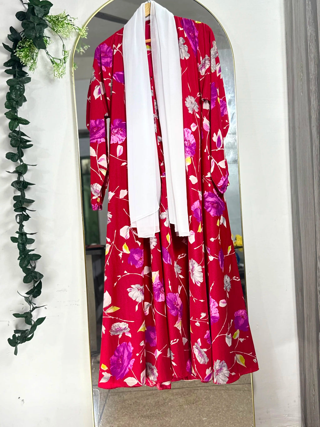 Wildflower Grace Abaya with a red base, multicolour floral print, and flowing full-length silhouette with open front