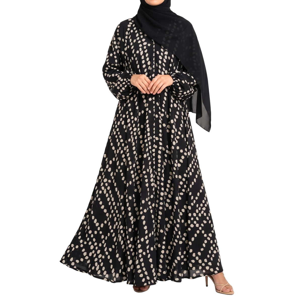 Pebble Muse Abaya with a black base, beige scattered spot print, and flowing full-length silhouette