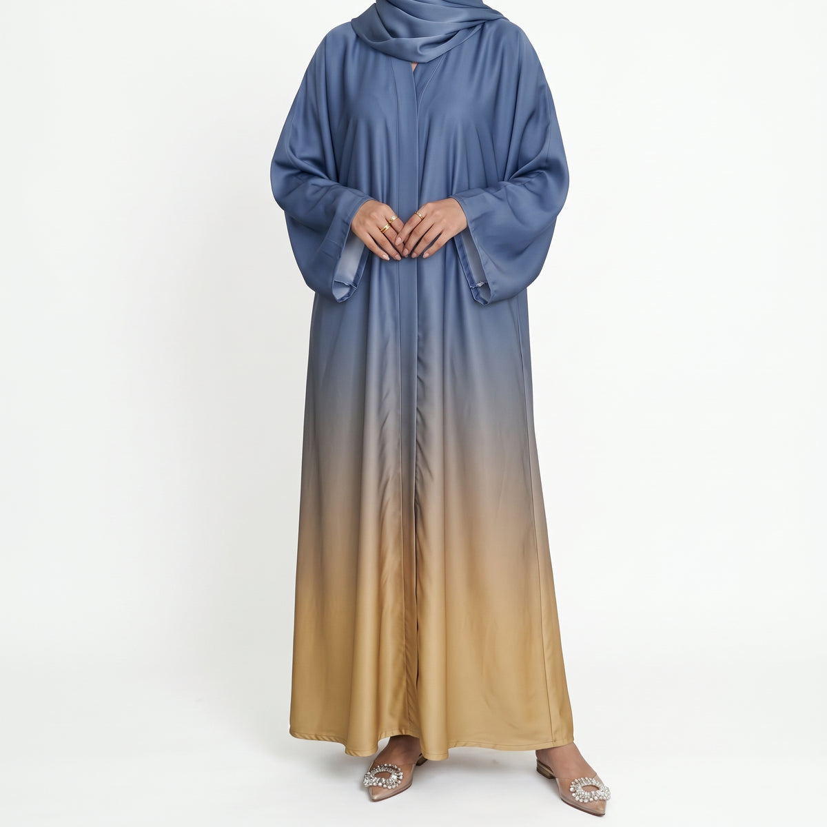 Full-length blue and beige ombré abaya with wide sleeves, styled with a blue headscarf.