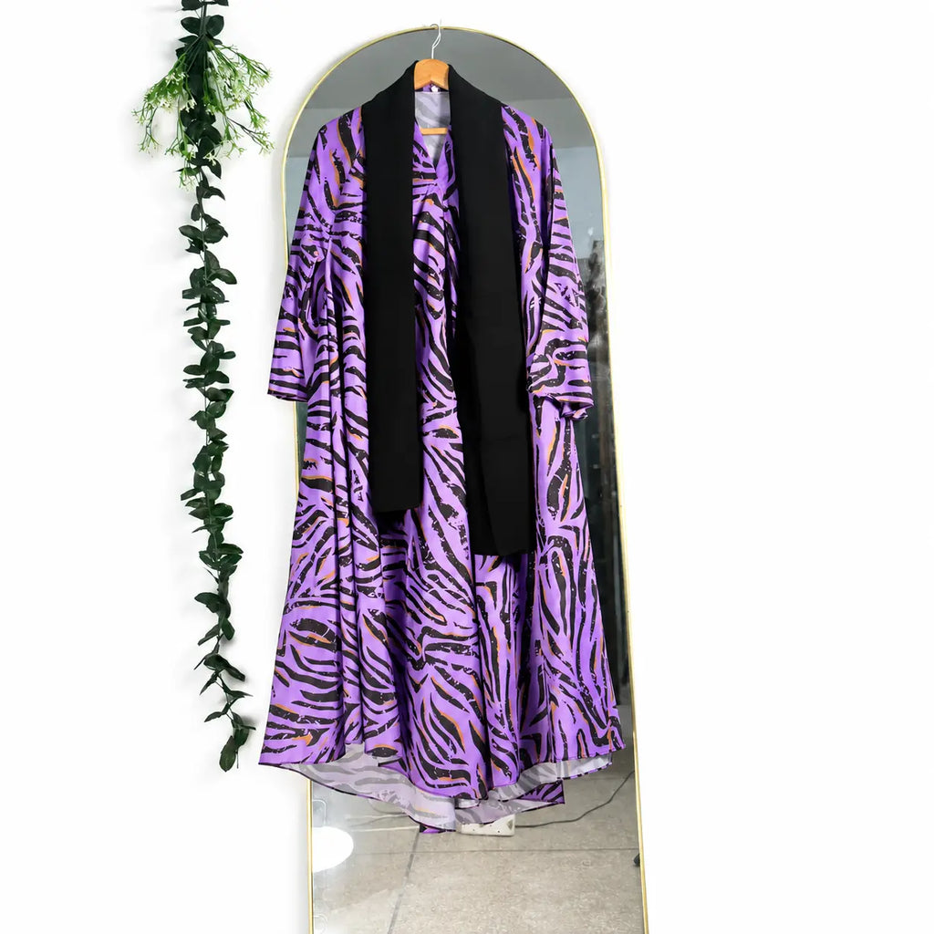 Wildstripe Abaya with a purple base, bold black abstract stripes, mustard accents, and a flowing full-length silhouette with front open