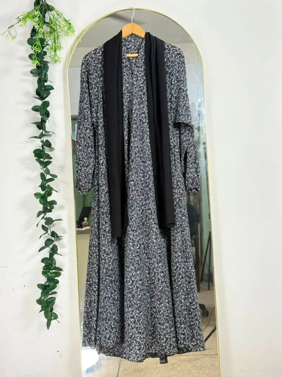 Stardust Print Abaya with a dark base, scattered white speckled pattern, and flowing full-length silhouette with front open